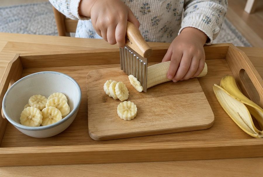 Toddler slicing a banana with a wavy chopper